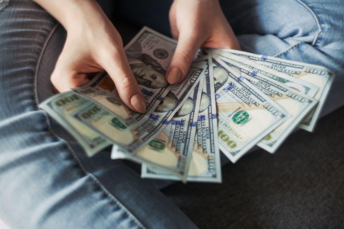 Person Holding Money - How Much Does Video Editing Cost