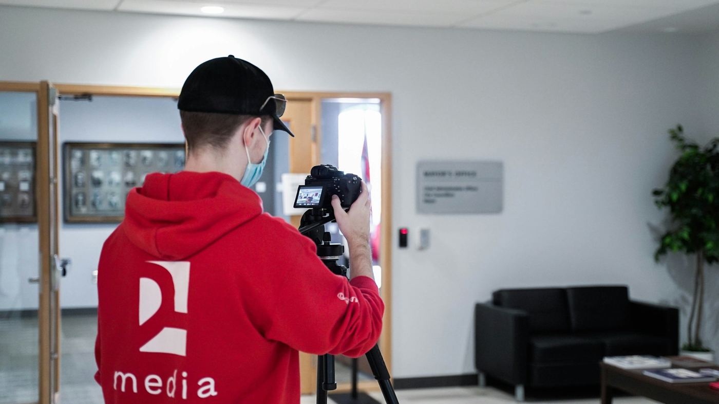 man using a camera - Types of Corporate Videos
