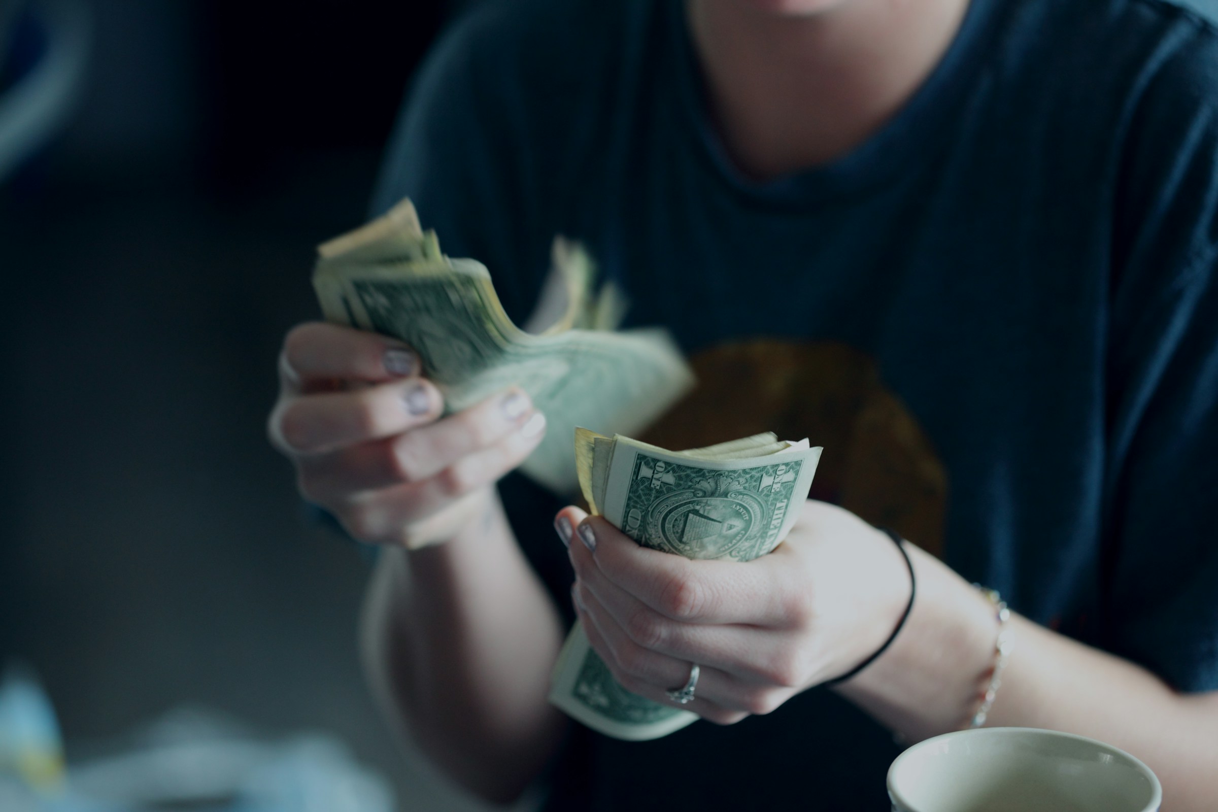 man counting dollar bills - Corporate Video Production Prices