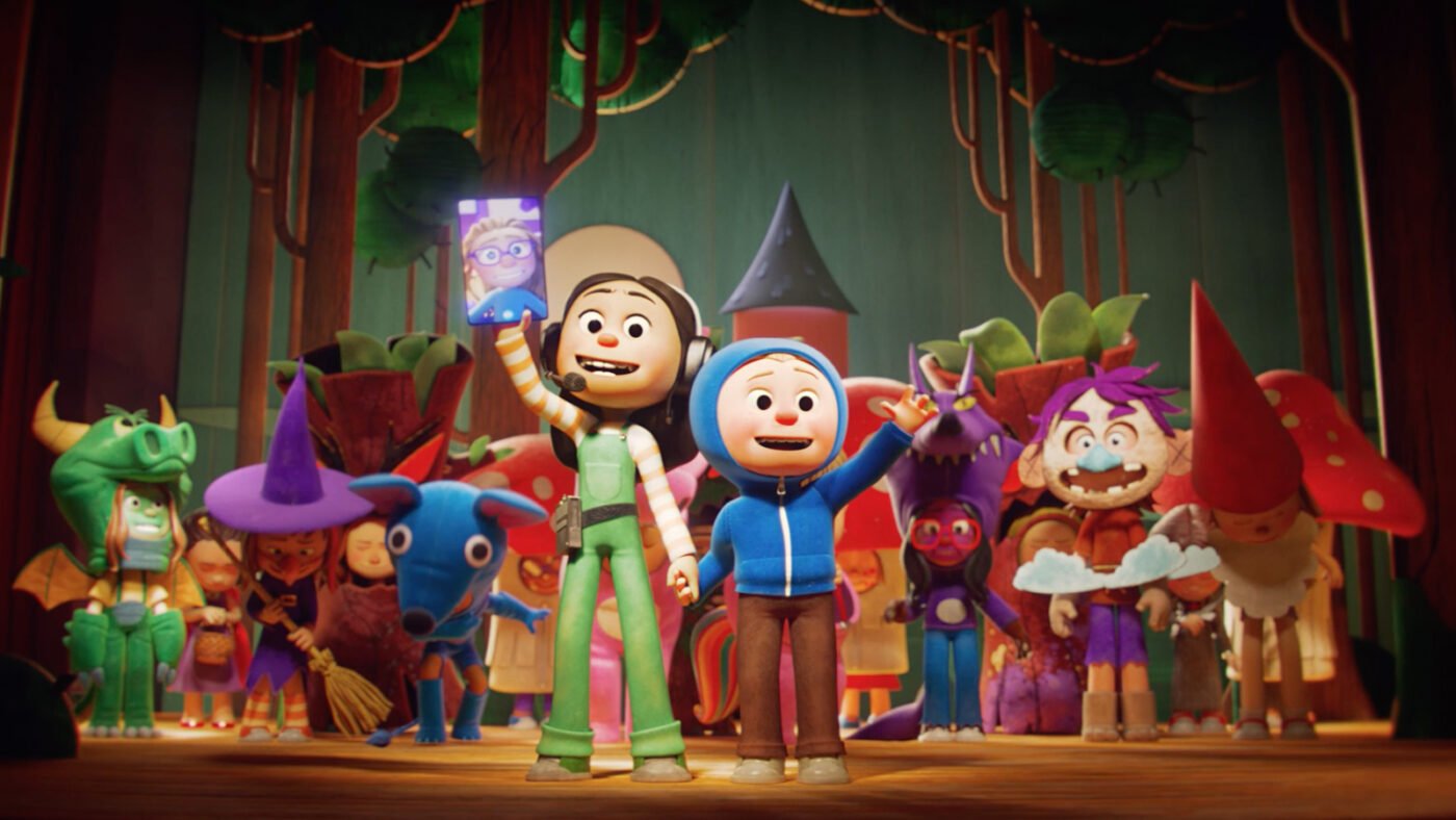 A crowd of colorful 3D animated characters on a theater stage, including a girl in green overalls holding up a phone and a boy in a blue hoodie