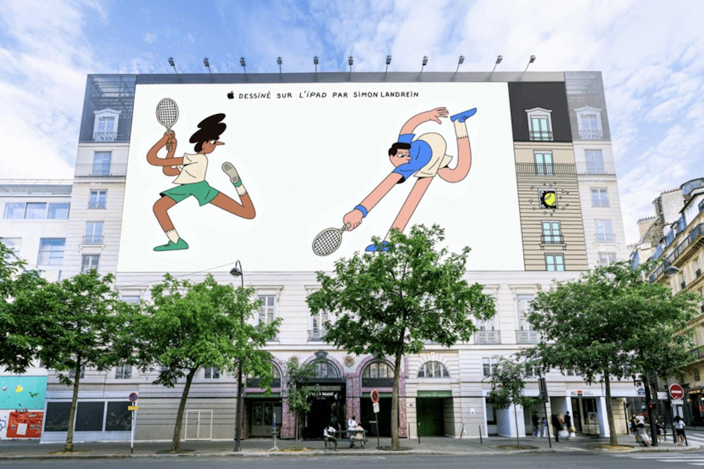 A building-sized Apple billboard in Paris showing two illustrated tennis players, with a tennis ball smashed through a window drawn into the facade