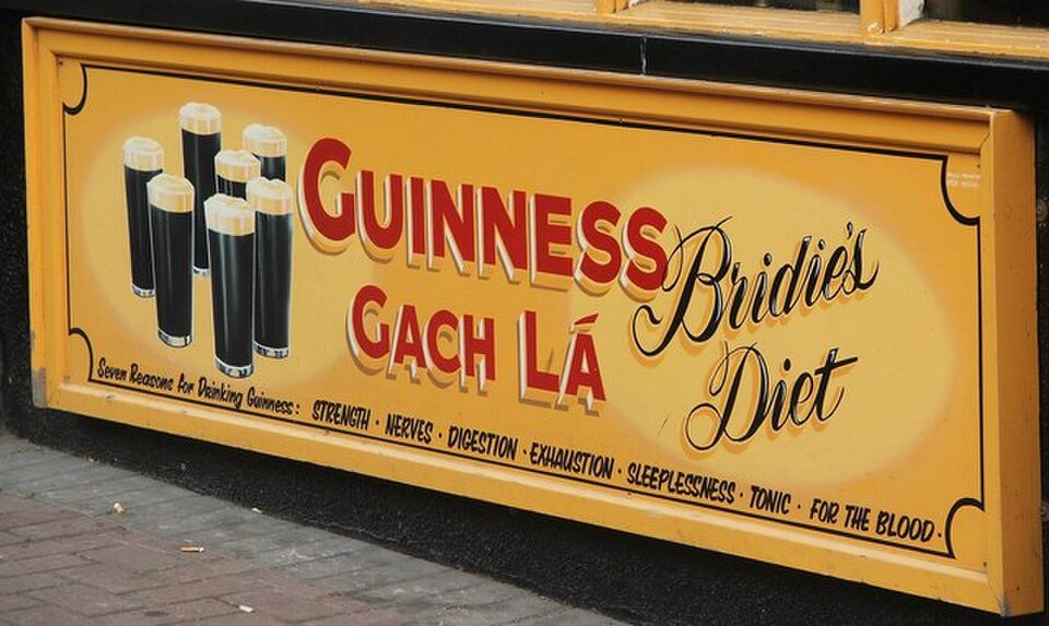 A vintage Guinness is good for you advertising sign painted on a wall in Ireland