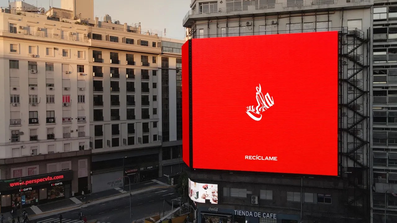 A large Recycle Me billboard in Buenos Aires showing the Coca-Cola logo crushed into the shape of a crumpled can