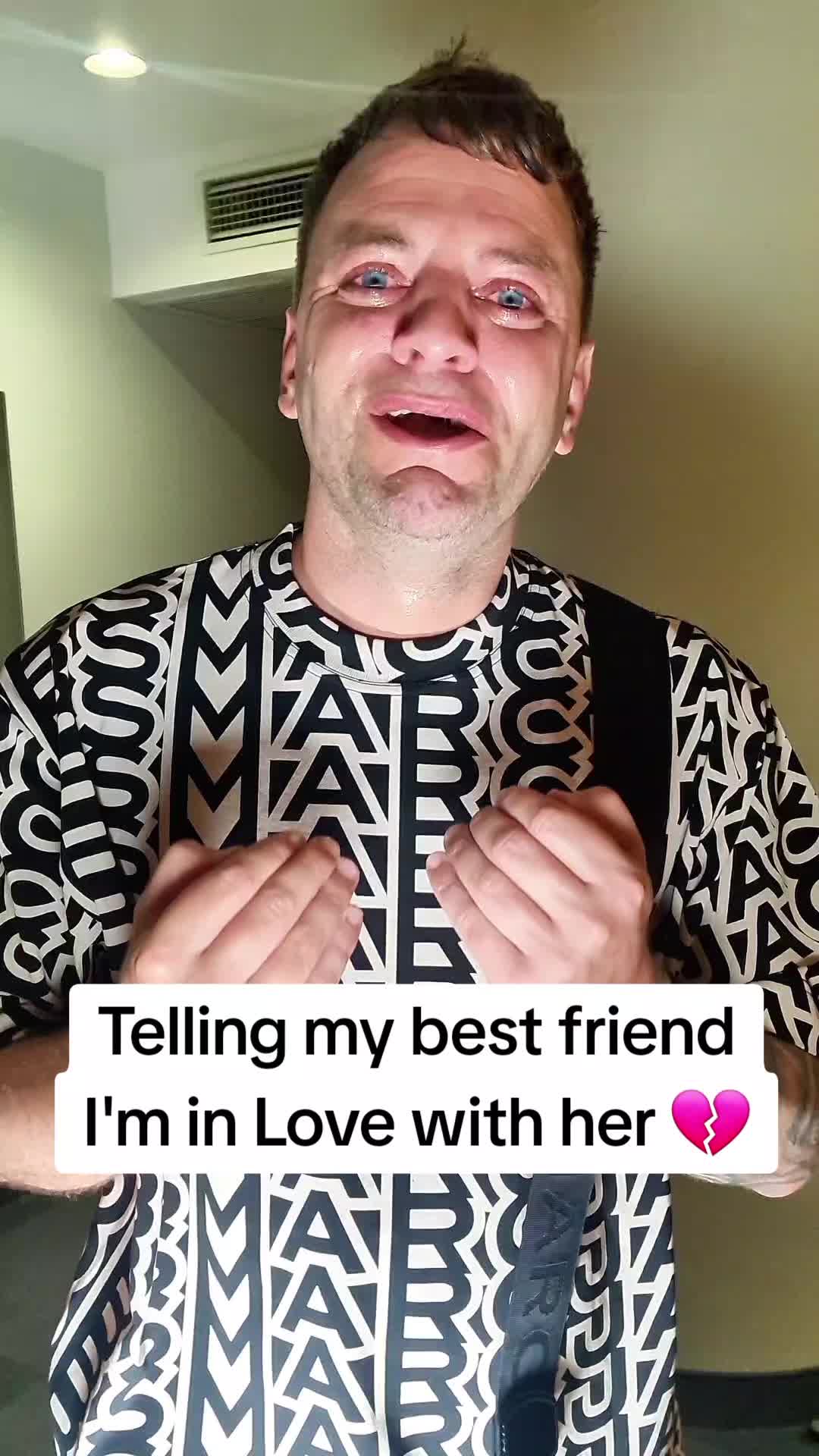 Creator Lewis Saunderson crying in a Marc Jacobs monogram shirt in a TikTok posted by the brand